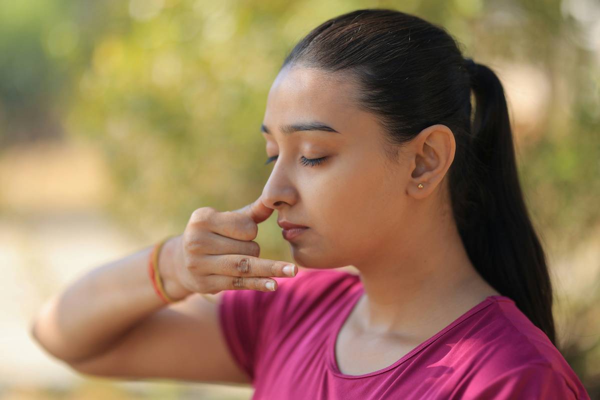 what is 4-7-8 breathing demonstrated by a person sitting calmly with eyes closed, hand on abdomen